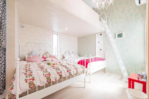 a bedroom with a white bed and a ladder at Papillon Paradis Nishi-Shinjuku in Tokyo