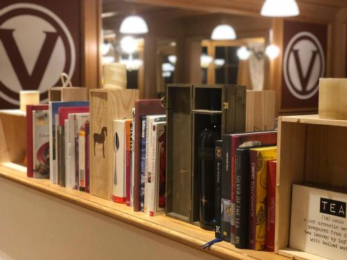 a row of books on a shelf in a store at Hotel Viktoria Eden in Adelboden