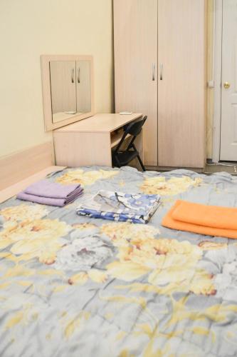 a room with a bed with a table and a desk at Vishnya Hostel in Dnipro
