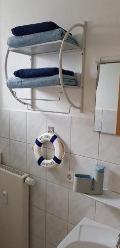 a bathroom with towels and a life preserver on the wall at Hotel Garni in Herborn