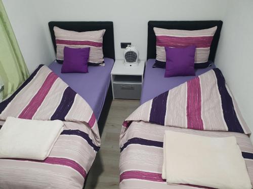 two beds sitting next to each other in a room at Guest House deluxe in Orašje