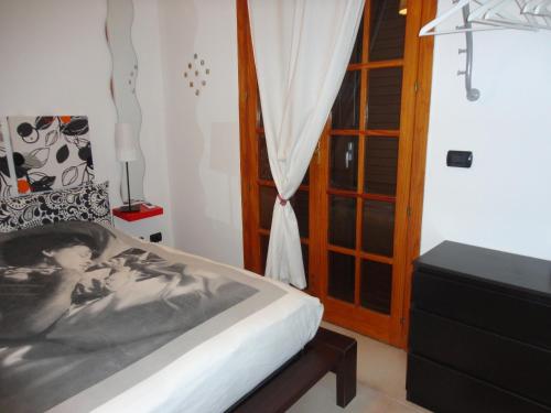 Schlafzimmer mit einem Bett und einem Fenster in der Unterkunft B&B Terra Marique in Syrakus