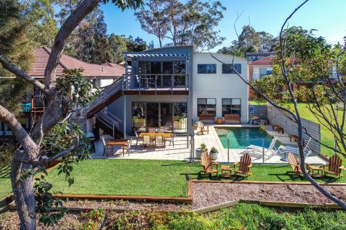a house with a pool and a yard at The Edgewater on Greville in Sanctuary Point