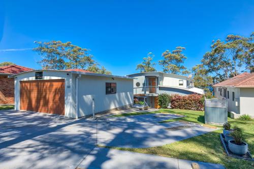 a house with a driveway and a garage at The Edgewater on Greville in Sanctuary Point