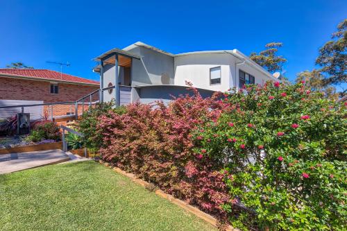 a house with pink flowers in the yard at The Edgewater on Greville in Sanctuary Point