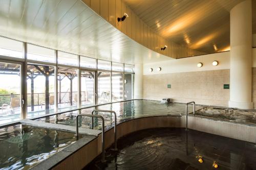 a large pool of water in a large building at Hotel Areaone Hiroshima Wing in Higashihiroshima