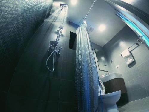 a bathroom with a shower and a toilet at Rain cha-am by J in Cha Am