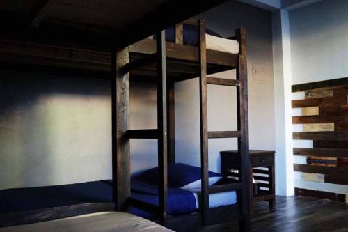 a bedroom with two bunk beds and a desk at Hostel Privado in Puerto Princesa City
