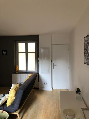 a living room with a couch and a table at appartement place stanislas in Nancy