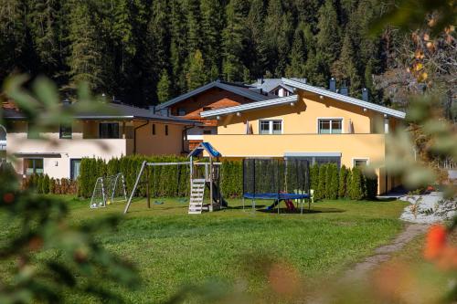a house with a yard with a playground at Appartement MonAlisa in Sölden
