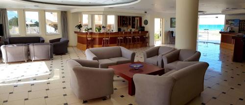 a lobby with chairs and a table in a room at Sunny Bay Hotel in Kissamos