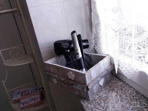 a box with a camera in it on the floor at Locanda 130 in Fonni