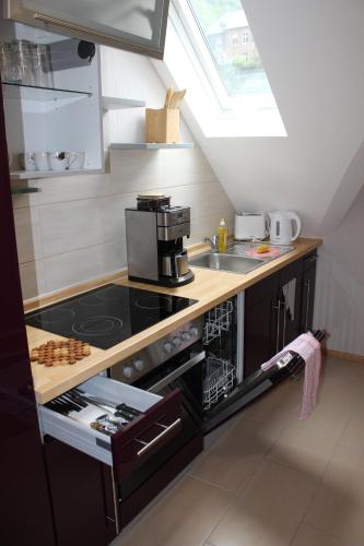 a kitchen with a stove and a sink at Posthotel in Bad Bertrich