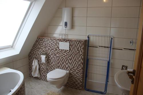 a small bathroom with a toilet and a sink at Posthotel in Bad Bertrich