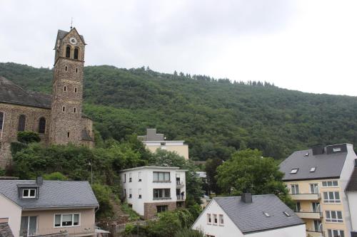 a church and a clock tower in a city at Posthotel in Bad Bertrich