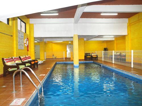 a large swimming pool in a building with a pool at Portimão Center Hotel in Portimão