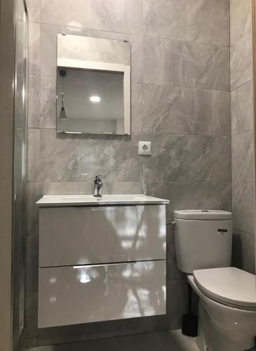 a bathroom with a sink and a toilet at Castle Apartment in Alicante