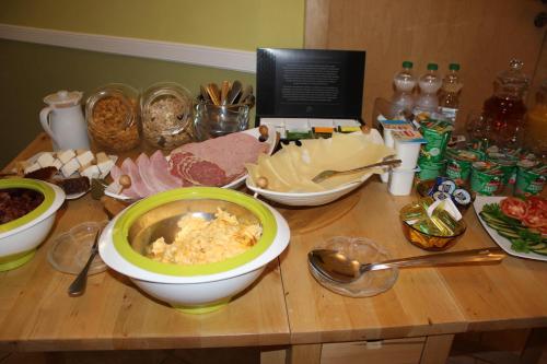 a wooden table with a bowl of food on it at Posthotel in Bad Bertrich