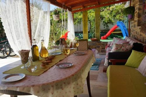 a table with glasses of wine on a patio at Stavies Traditional Stone House in Stáviai