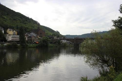 a bridge over a river with houses and a town at Posthotel in Bad Bertrich