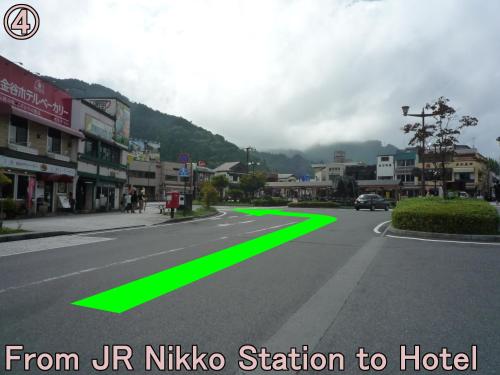 an empty street with a green line on the road at Nikko Station Hotel 2 in Nikko