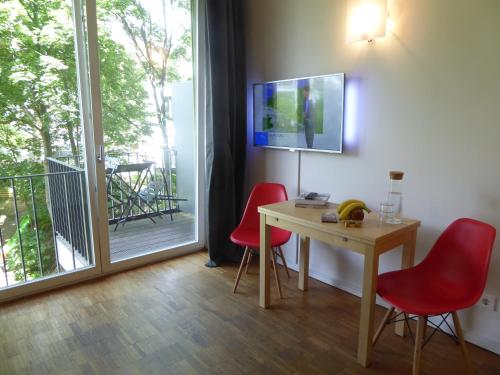 a room with a table and chairs and a sliding glass door at Apartments Am Friedrichshain in Berlin