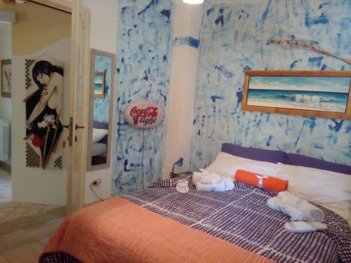 a bedroom with a bed with a blue wall at Casa d' Artista B&B in Ozieri