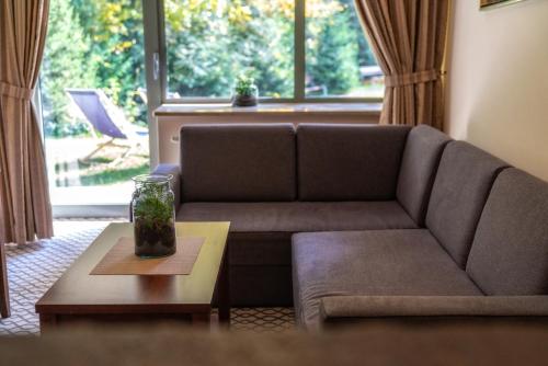 a living room with a couch and a table at Hotel Murowanica in Zakopane