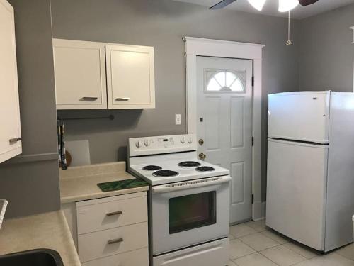 a kitchen with a white stove and a refrigerator at Bright, Clean, Private. In the Heart of Downtown! Parking, Wi-Fi and Netflix included in Ottawa