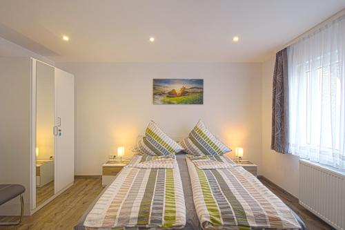 a bedroom with two beds and a window at Ferienhaus an der Burg Namedy in Andernach