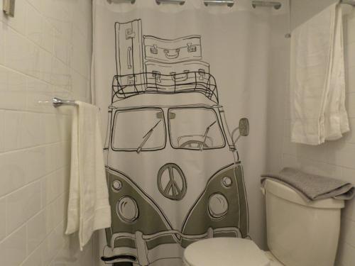 a bathroom with a toilet and a shower curtain at Fantastic and Modern Downtown 1-Bed Basement Apt., parking Wi-Fi and Netflix included in Ottawa