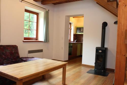 a living room with a wood stove in a room at Chata Koutík in Loučná nad Desnou