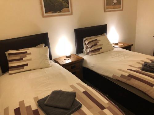two beds sitting next to each other in a bedroom at White Horse Tavern in Telford