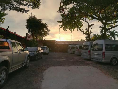 a row of parked vehicles in a parking lot at Khong Chiam Hotel in Khong Chiam