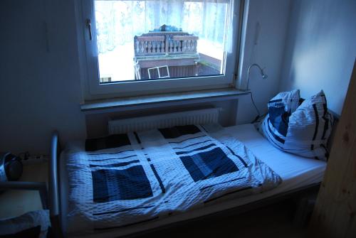 a bed in a room with a window at 6 Schulstraße in Bieber