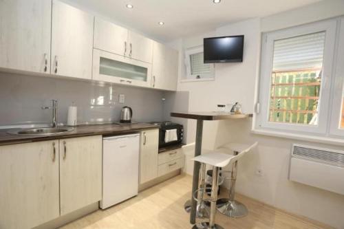 a kitchen with white cabinets and a sink at Seher in Sarajevo