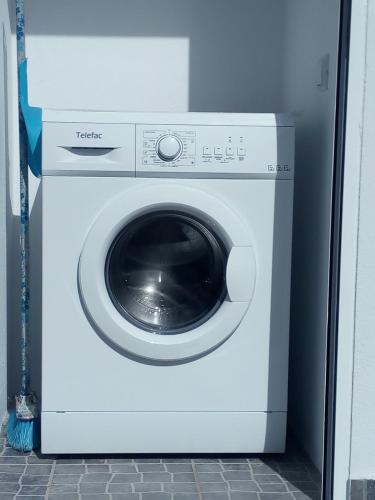 a white washing machine sitting in a room at Refúgio da Sancheira Grande in Óbidos