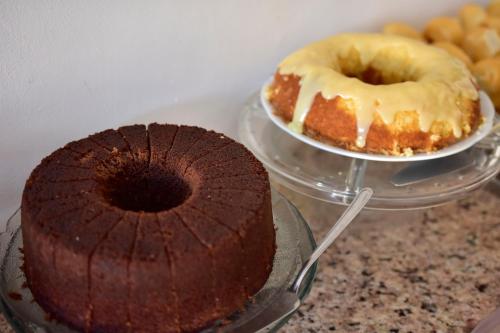 a chocolate cake and a donut on a plate at Estalagem 11 Suites in Arraial do Cabo