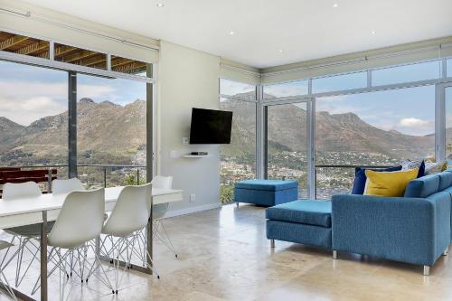 a living room with a view of the mountains at Mount Bay in Hout Bay