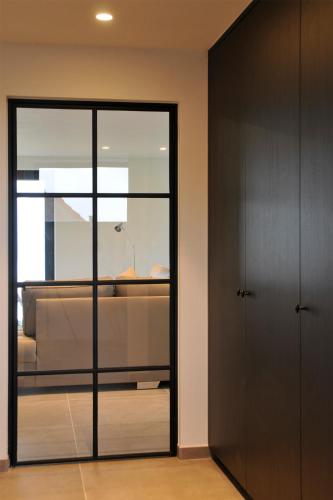 a bedroom with a bed and a sliding glass door at Maison la Belle Vue in Mont-de-l'Enclus