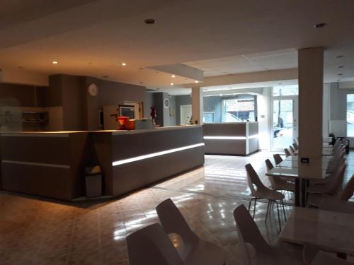 a lobby with chairs and a counter in a building at Hotel Luis III in Mar del Plata