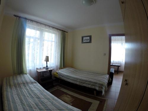 a hotel room with two beds and a window at OW Mikomania in Charzykowy