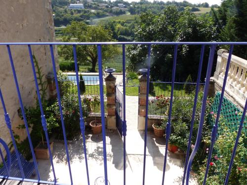 a blue metal gate with potted plants on it at Cottage du Château "Les Sources d'Arvory" in Valensole