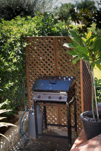 a grill sitting on a table in a garden at Villa Iaia in Fontane Bianche