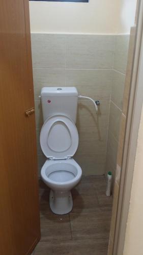 a bathroom with a white toilet in a stall at IsMa Lumut Homestay in Lumut
