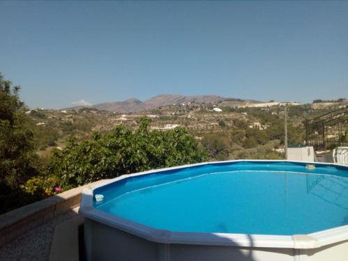 a blue swimming pool with a view of the mountains at Beautiful Benissa Views in Benissa