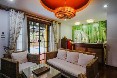 a living room with two chairs and a table at Lamduan Boutique Homestay in Chiang Mai