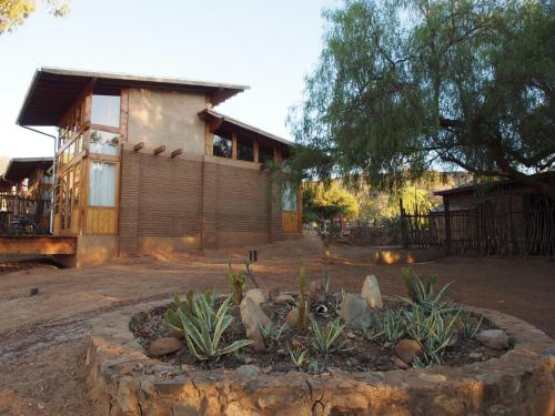 a house with a garden in front of it at Casa Mayoral B&B Pet friendly in Valle de Guadalupe