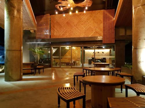 um restaurante com mesas e cadeiras num edifício em EcoLoft Hotel - SHA Plus em Cidade Phuket