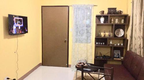 a living room with a door and a book shelf at Jireh’s Guests Home in Butuan